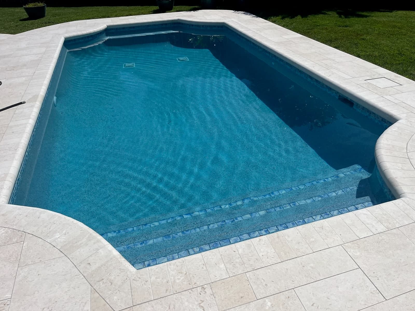 Pool with travertine coping and glass tile steps